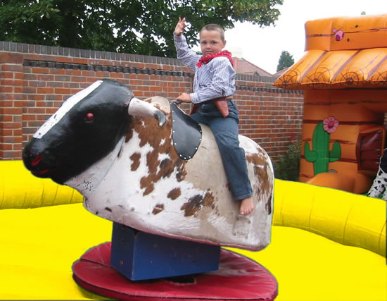 Kids riding rodeo bull